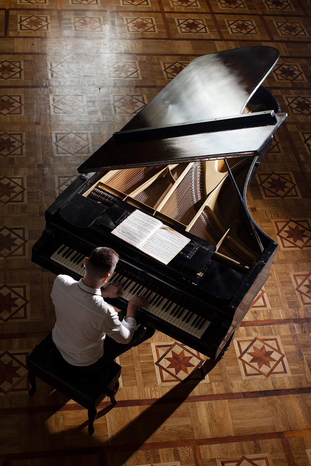 man playing piano top view